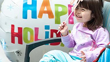 Young girl smiling in a wheelchair